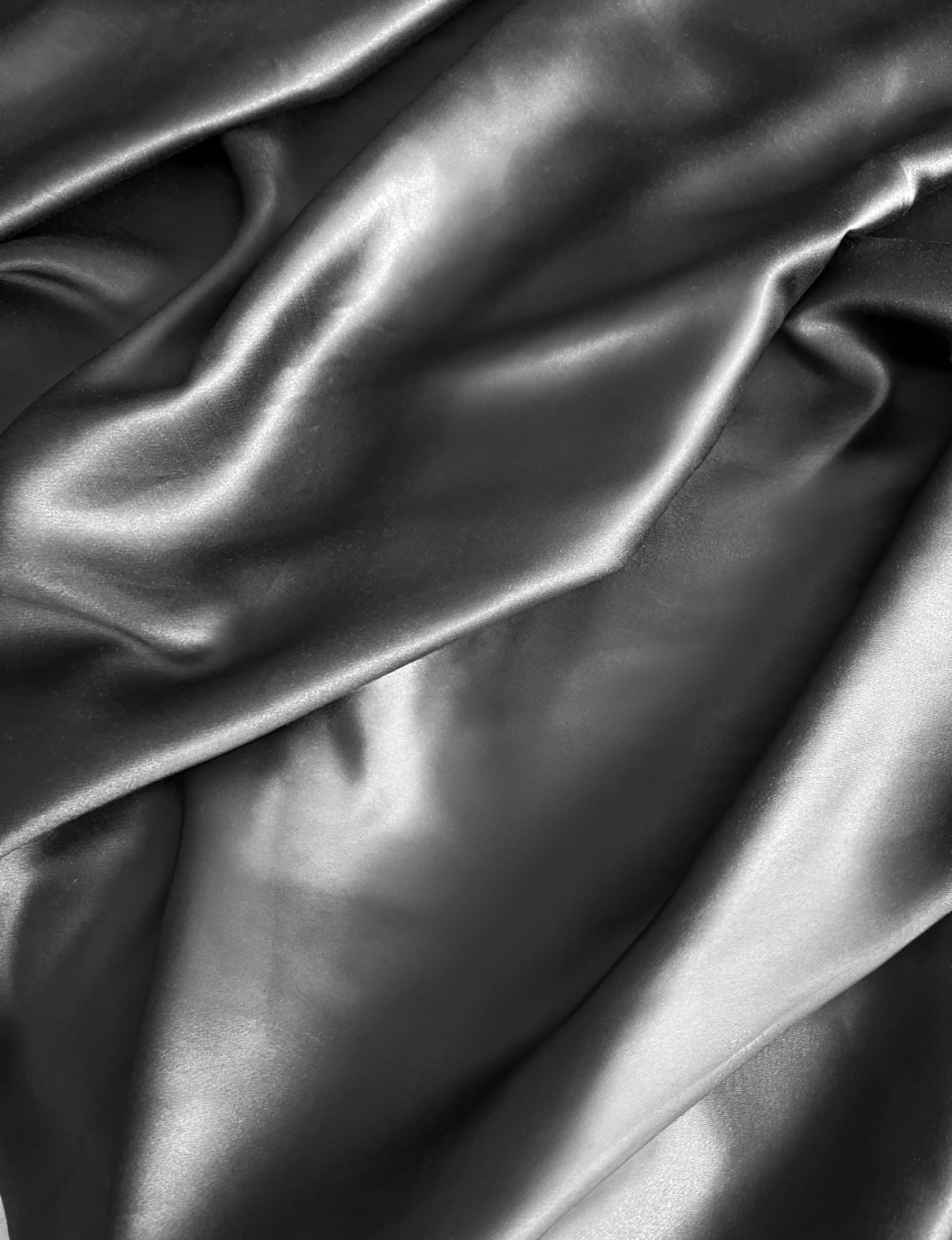 Soft folds of bamboo viscose fabric in Storm Gray — natural sheen and silky texture by Innocent Allure Enterprises.

