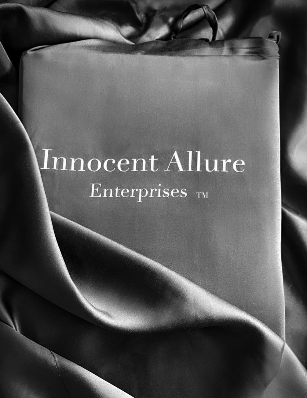 Branded Innocent Allure Enterprises packaging on bamboo viscose sheet bundle — wrapped in elegant fabric.

